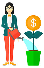 Image showing Woman watering money flower.