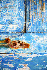 Image showing   paint in blue wood door rusty nail