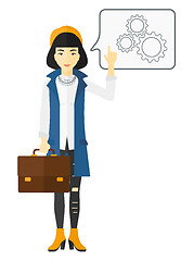 Image showing Business woman pointing at cogwheels.