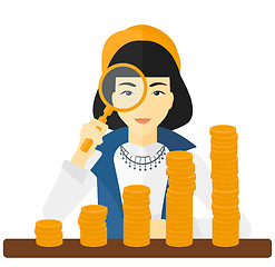 Image showing Woman with magnifier and golden coins. 