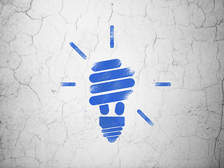 Image showing Finance concept: Energy Saving Lamp on wall background