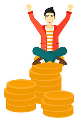 Image showing  Happy businessman sitting on coins.