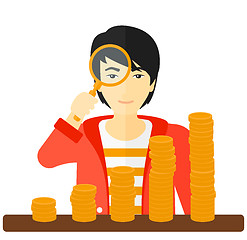 Image showing Man with magnifier and golden coins. 