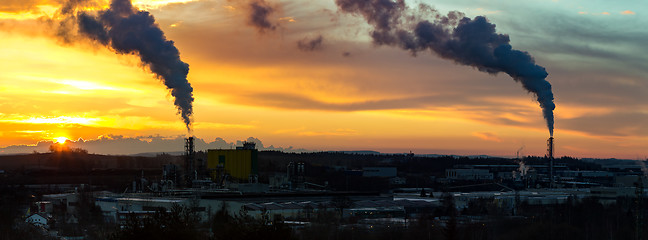 Image showing Sunrise silhouette of smoking factory