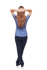 Image showing Back view of a woman standing with hands over head