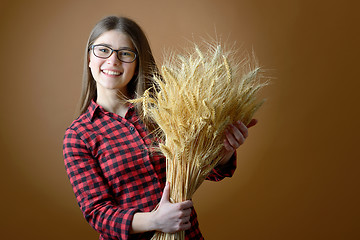 Image showing girl hold in hand bunch of wheat stalks