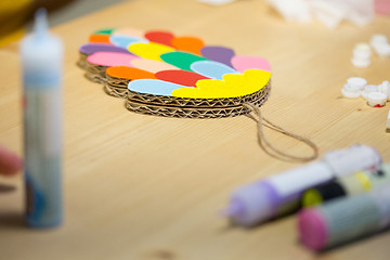 Image showing Colorful toys made of cardboard on a wooden table.