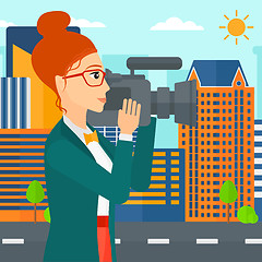 Image showing Camerawoman with video camera.