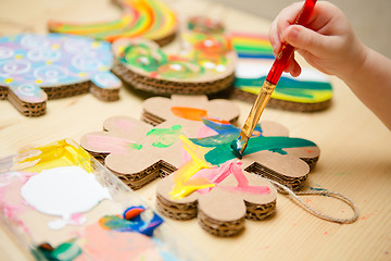 Image showing Little female baby painting with colorful paints