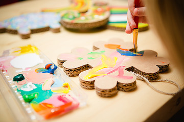 Image showing Little female baby painting with colorful paints