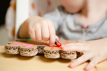 Image showing Little female baby painting with colorful paints