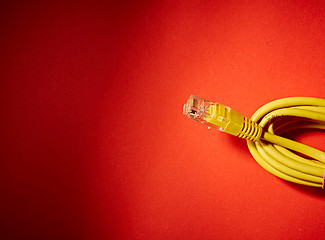 Image showing yellow network cable on red background