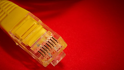 Image showing yellow network cable on red background