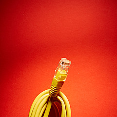 Image showing yellow network cable on red background