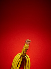 Image showing yellow network cable on red background