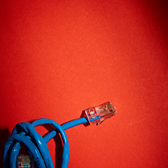 Image showing Blue network cable on red background