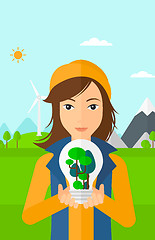 Image showing Woman with lightbulb and trees inside.