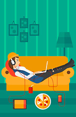 Image showing Woman lying on sofa with many gadgets.