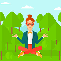 Image showing Business woman meditating in lotus pose.