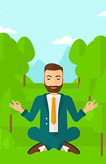 Image showing Businessman meditating in lotus pose.