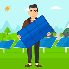 Image showing Man holding solar panel.