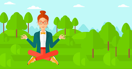 Image showing Business woman meditating in lotus pose.