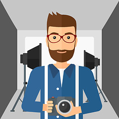 Image showing Smiling photographer holding camera.