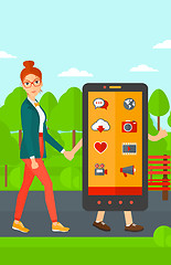 Image showing Woman walking with smartphone.