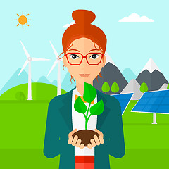 Image showing Woman holding plant.