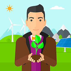 Image showing Man holding plant.