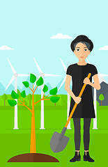 Image showing Woman plants tree.