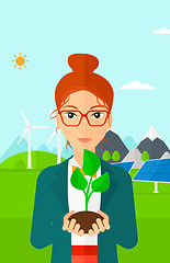 Image showing Woman holding plant.