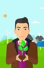 Image showing Man holding plant.