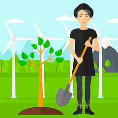 Image showing Woman plants tree.