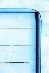 Image showing nail stripped   in the blue wood door  rusty 