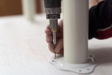 Image showing repairman working with drilling machine