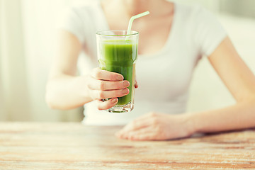 Image showing close up of woman hands with green juice