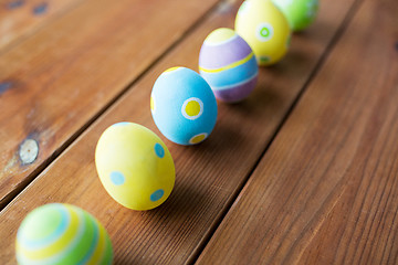 Image showing close up of colored easter eggs on wooden surface