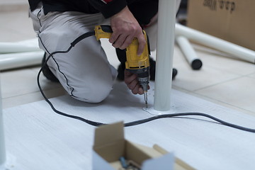 Image showing repairman working with drilling machine