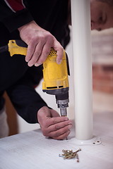 Image showing repairman working with drilling machine