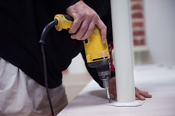 Image showing repairman working with drilling machine