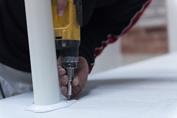 Image showing repairman working with drilling machine