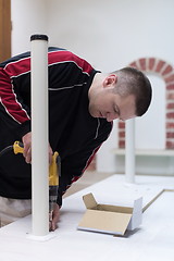 Image showing repairman working with drilling machine