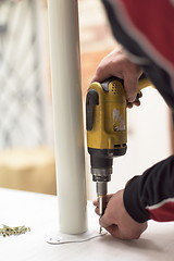 Image showing repairman working with drilling machine