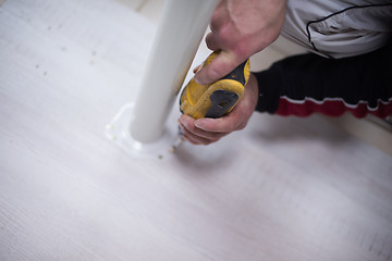 Image showing repairman working with drilling machine