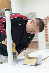 Image showing repairman working with drilling machine