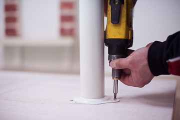 Image showing repairman working with drilling machine