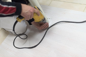 Image showing repairman working with drilling machine