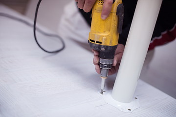 Image showing repairman working with drilling machine