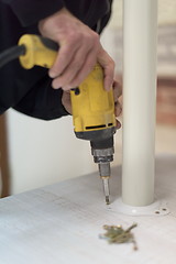 Image showing repairman working with drilling machine